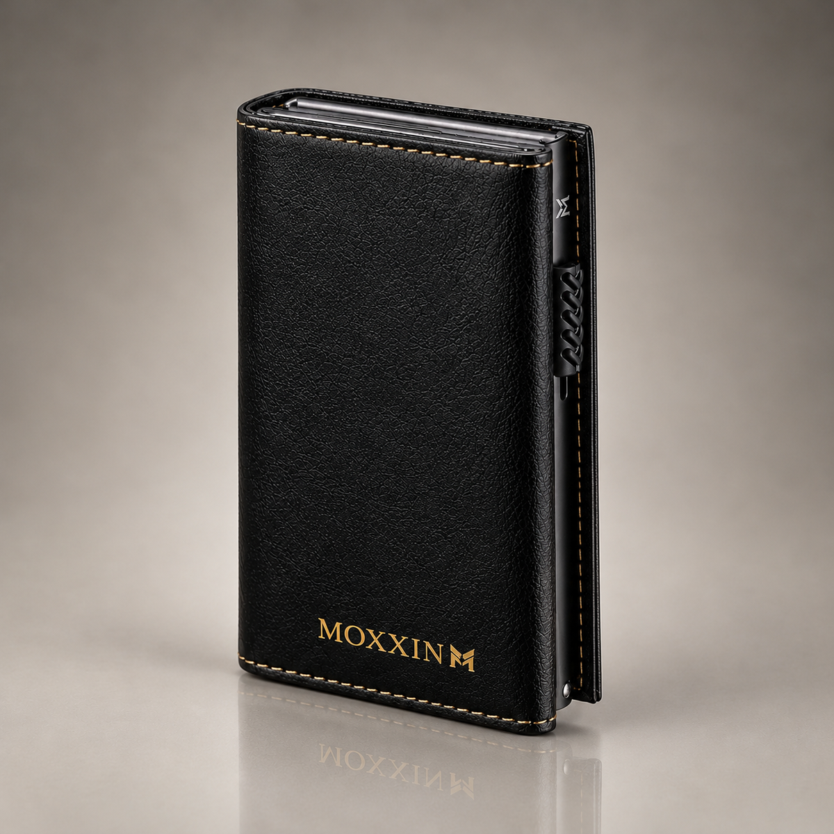 Moxxin black leather pop-up wallet, closed, with gold embossed logo and gold stitching